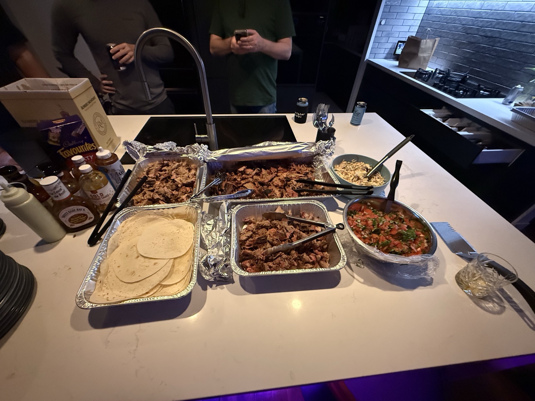 The JPL full spread laid out for dinner — smoked meat, tortillas, slaw and pico de gallo